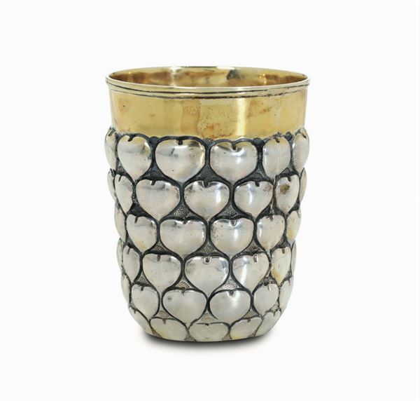 An embossed and chiselled silver glass with a heart-shaped decor, partially gilt, UK 20th century