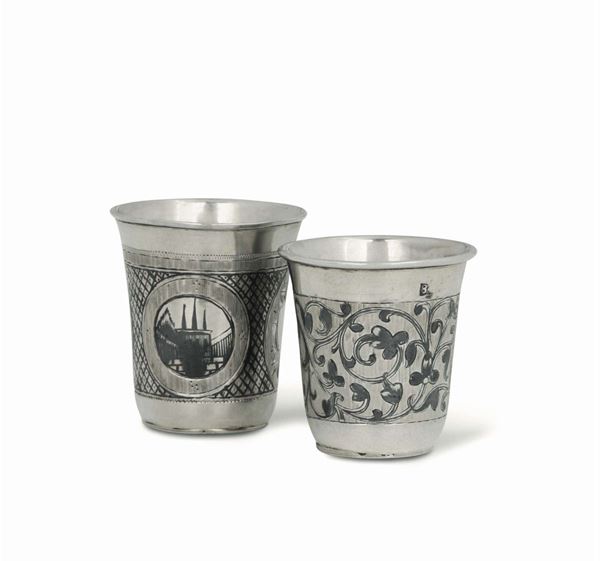 Two small glasses in embossed, chiselled and gilt silver and niello, with a botanical and geometric decor. One Moscow 19th century, one Russia 19th century