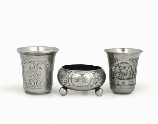 A group of two glasses and a bowl in embossed and chiselled silver, one Russia 19th century, one Moscow 1891, the bowl Moscow 1891