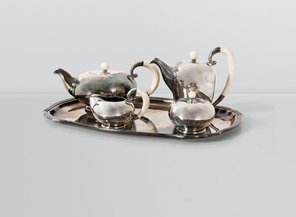 A silver tea set made up by a teapot, a coffee pot, a milk jug and a sugar pot. Bone details. Manufacture punches. Italy, 1930 ca.