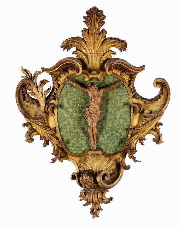 Crocifisso in legno scolpito entro cornice intagliata e dorata, XIX secolo
