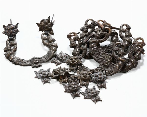 Lotto di otto maniglie in metallo con mascheroni, XVIII-XIX secolo