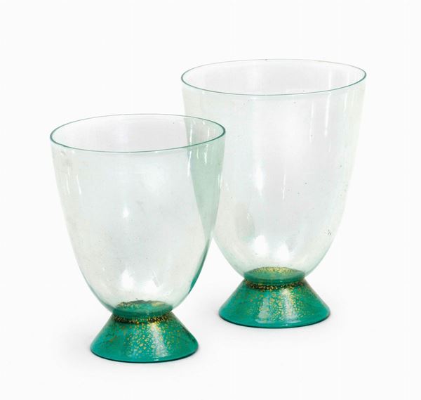 Carlo Scarpa, M.V.MTwo green blown glass drinking glasses with a gold leaf decor. H 10cm, diameter 7.5cm; H 9cm, diameter 7cm. Cappellin, Murano, 1930 ca