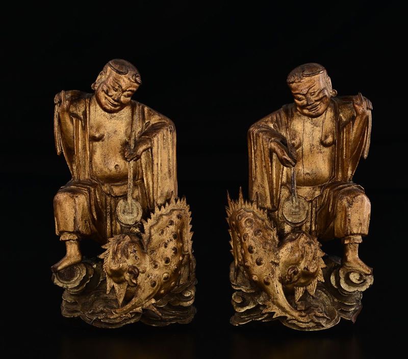 Coppia di sculture in legno dorato raffiguranti saggi con cani di Pho, Cina, Dinastia Qing, epoca Kangxi (1662-1722)  - Asta Fine Chinese Works of Art - Cambi Casa d'Aste