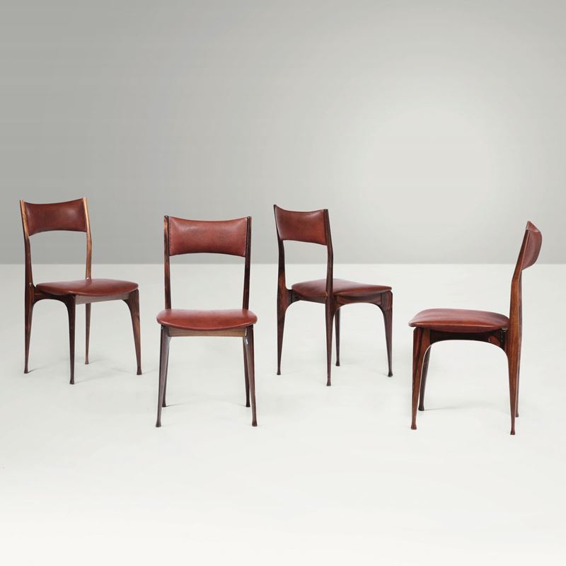 Quattro sedie in legno di palissandro con rivestimenti in skai.  - Asta Design - Cambi Casa d'Aste