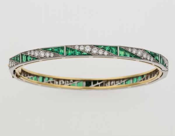Diamond, hydrothermal emerald, gold and platinum bangle. Signed Enrico Cirio