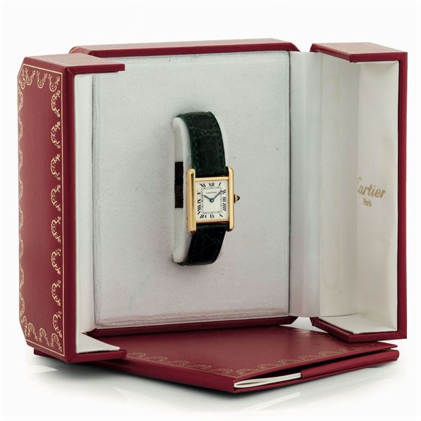 Cartier, Tank . Fine, 18K yellow gold lady's wristwatch with original buckle. Accompanied by the original box and Guarantee. Sold in 1991