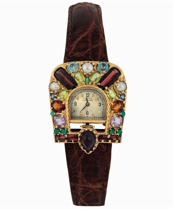 LUCIEN PICCARD. Raro, orologio da polso, in oro giallo 14K con pietre di colore. Realizzato nel 1960 circa