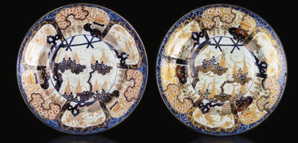 Coppia di grandi piatti in porcellana Arita con scene naturalistiche entro riserve e decori floreali, Giappone, fine XVII secolo