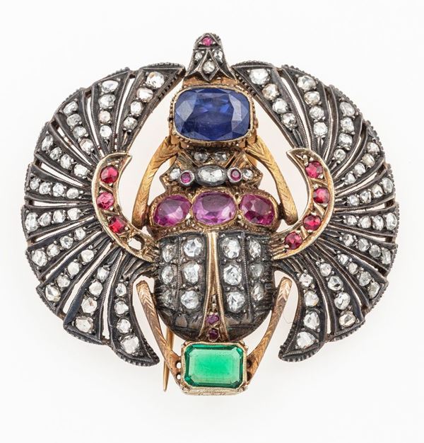 Egyptian revival silver, gold, emerald, ruby and old-cut diamond brooch. The front decorated with a scarab