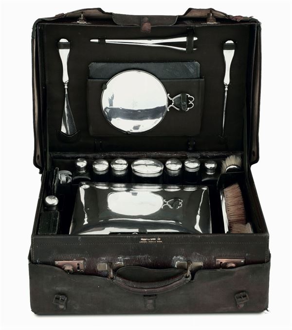 A silver and glass toiletry set within case, London, 1911
