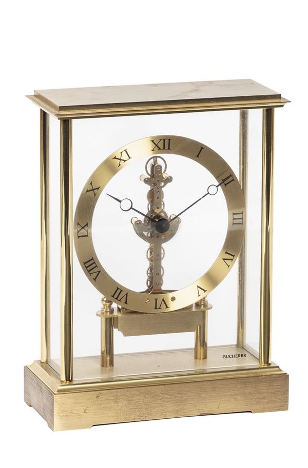 BUCHERER - Brass table watch with roman numerals and skeleton movement.