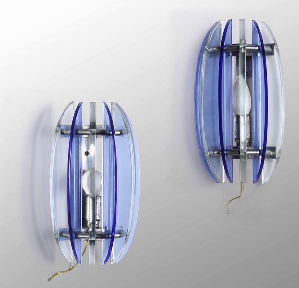 Coppia di appliques con struttura in metallo e diffusori in vetro colorato molato.