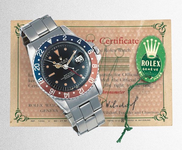 ROLEX - GMT-Master 1675 stainless steel dual-time wristwatch with date at 3 o'clock. Equipped with box and warranty.
