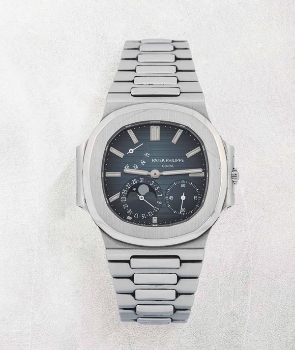PATEK PHILIPPE - Fine and rare stainless steel Nautilus with date and moon phase. Provided with full  [..]