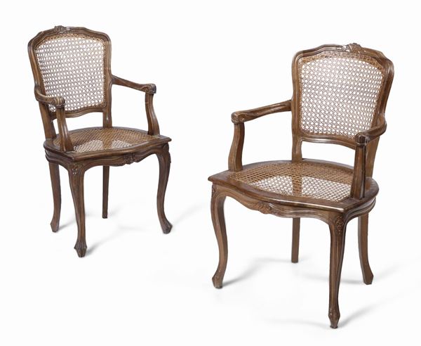 Due poltroncine in legno intagliato con seduta e schienale in cannetè, XX secolo