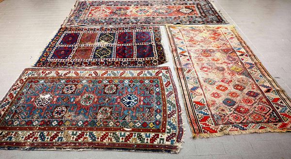 Lotto di quattro tappeti, tre caucasici e uno persiano, fine XIX secolo