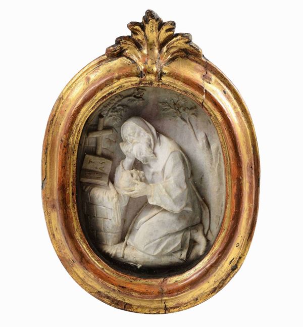 Meditazione di Sant’Antonio Abate. Rilievo in marmo entro teca in legno intagliato e dorato. Arte barocca italiana del XVIII secolo