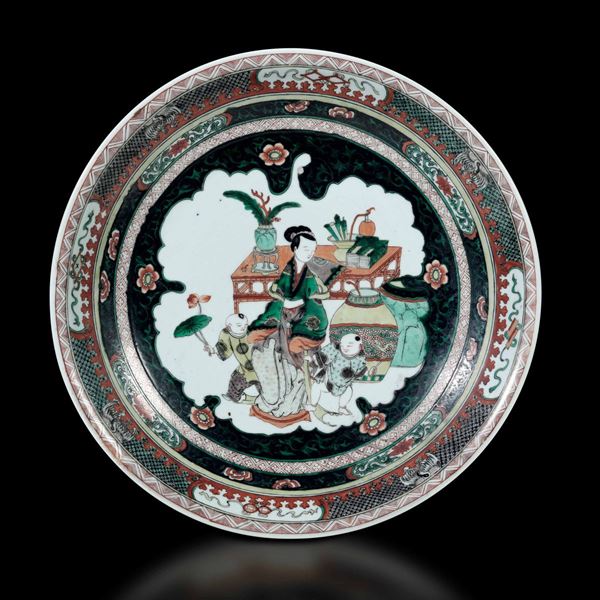 Piatto in porcellana Famiglia Verde con figura di donna e fanciulli entro riserva centrale, Cina, Dinastia Qing, marca e del periodo Kangxi (1662-1722)