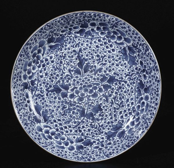 Piatto in porcellana bianca e blu con decori vegetali, Cina, Dinastia Qing, epoca Kangxi (1662-1722)