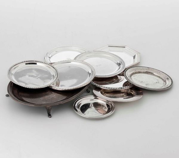 Dieci piattini in argento differenti di cui uno con piedini. Manifatture differenti del XX secolo