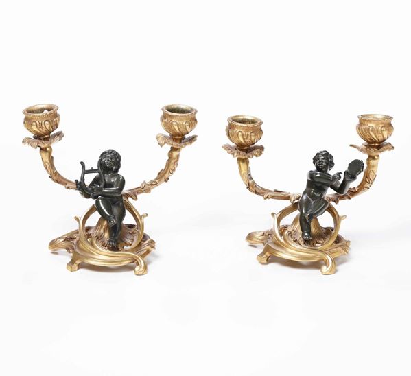 Coppia di doppieri in bronzo patinato e bronzo dorato, XIX secolo