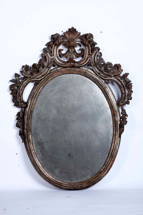 Specchiera ovale in legno intagliato, XIX secolo