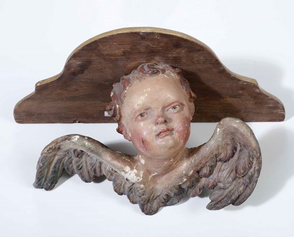 Testina di angelo in legno intagliato e dipinto