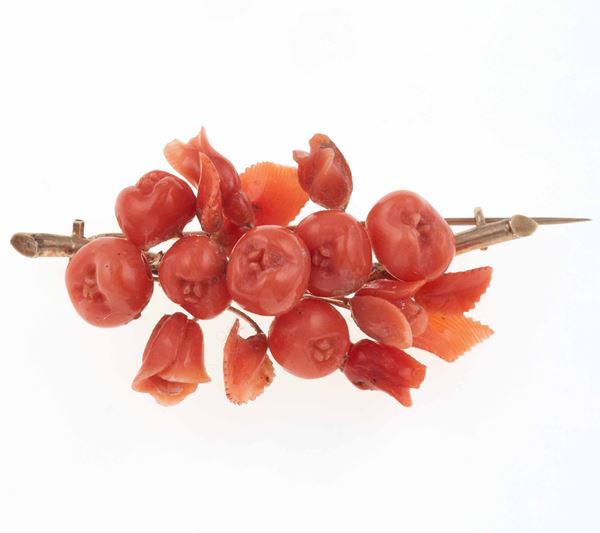 Carved coral and low-karat gold brooch