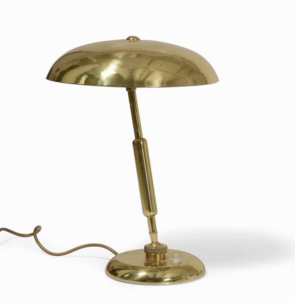 Lampada da tavolo orientabile con struttura e diffusore in ottone.