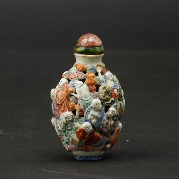 Snuff bottle in porcellana con decoro di personaggi a  traforo e a rilievo, Cina, Dinastia Qing, XIX secolo