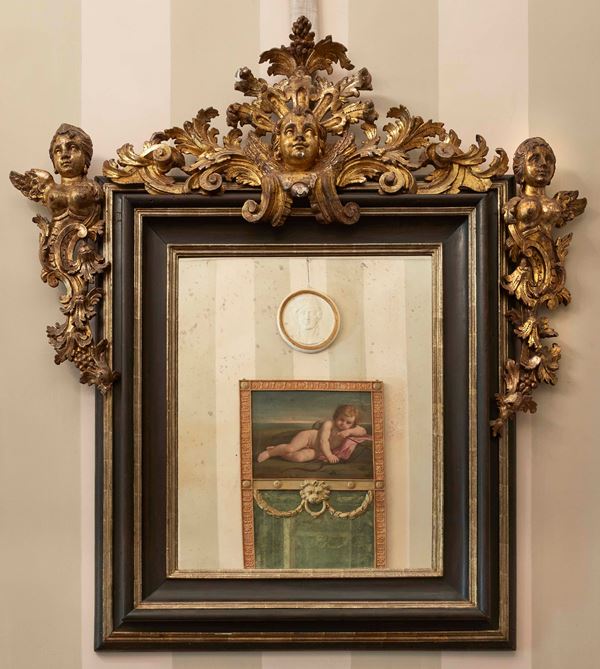 Importante coppia di specchiere barocche in legno scolpito, ebanizzato e dorato a mecca. Roma inizi XVII secolo