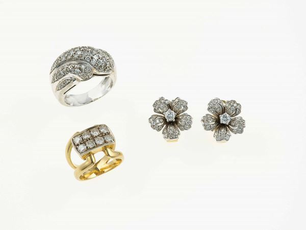 Two diamond and gold rings and a pair of diamond and gold earrings