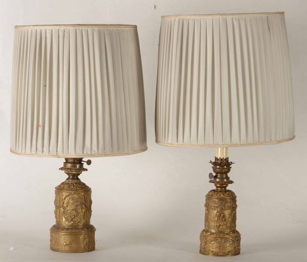 Due lampade da tavolo diverse in metallo dorato con decori in rilievo. XX secolo