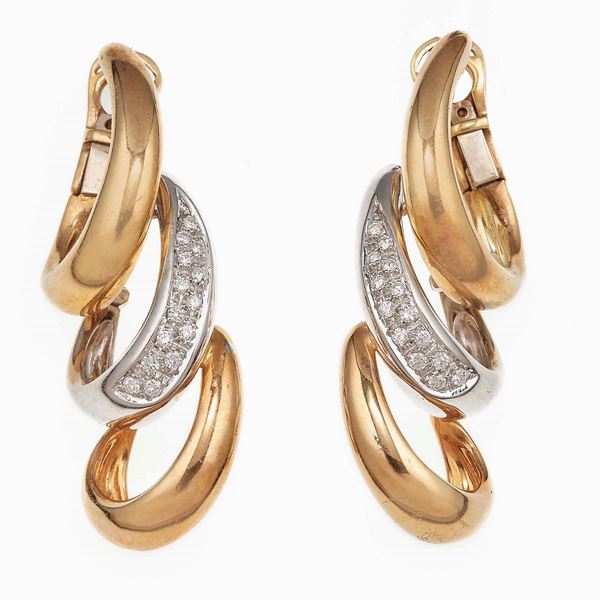 Pair of diamond and gold earrings. Signed Damiani
