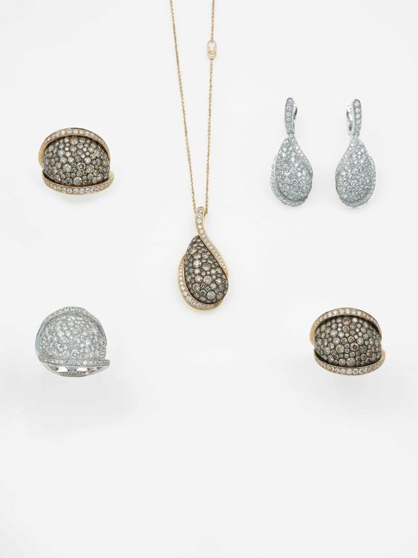 Group of three rings, a pair of earrings and a pendent necklace