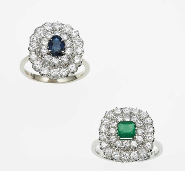 One emerald and diamond cluster ring and one sapphire and diamond cluster ring