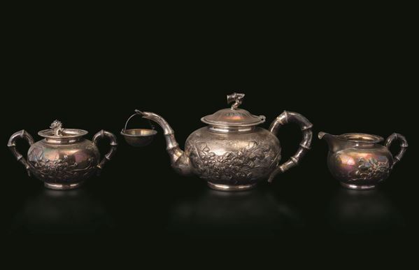 A silver tea set, China, Qing Dynasty, 1800s A teapot, a sugar pot with spoon and a milk jug.