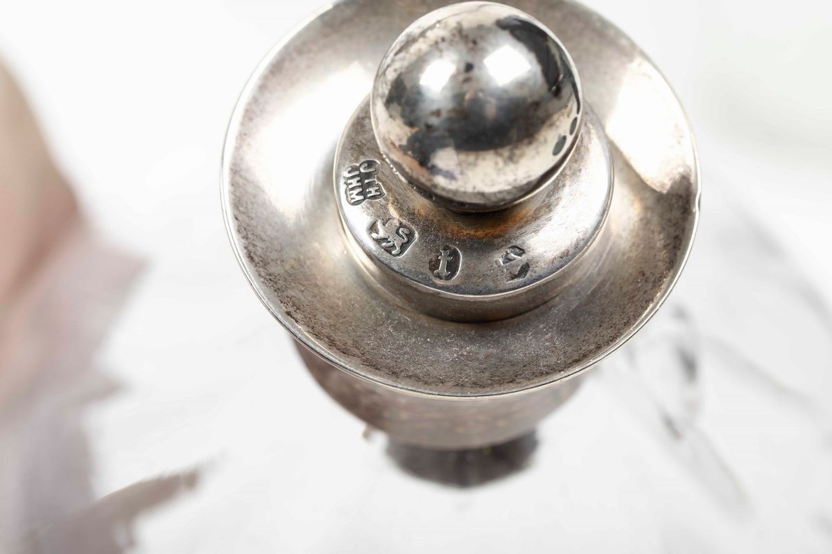 Lotto Composto da Otto Bottiglie e una Scatola in Vetro con Tappi e Ghiere in Argento. Varie Mani...