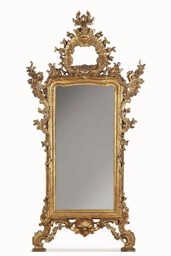 Specchiera in legno intagliato e dorato. XIX-XX secolo