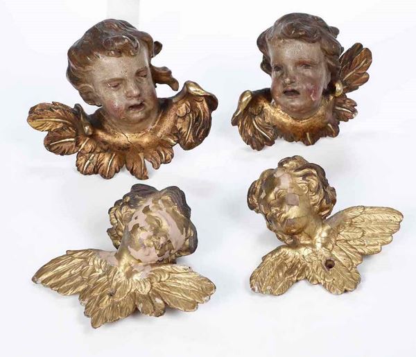Quattro testine di cherubini. Legno intagliato, laccato e dorato. XVIII-XIX secolo