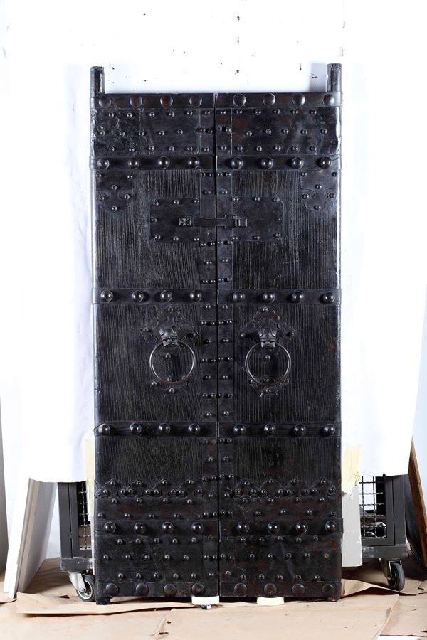A wooden double door with wrought iron details, China