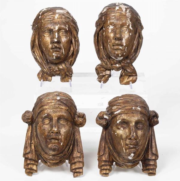 Quattro volti femminili in legno intagliato e dorato