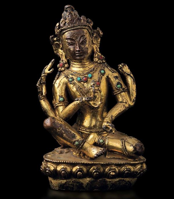 Figura di Avalokitesvara seduta su fiore di loto in bronzo dorato con tracce di policromia e innesti di pietre dure, Tibet, XV-XVI secolo