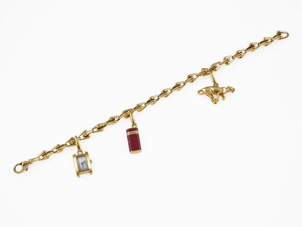 Gold charms bracelet. Signed Cartier. Fitted case