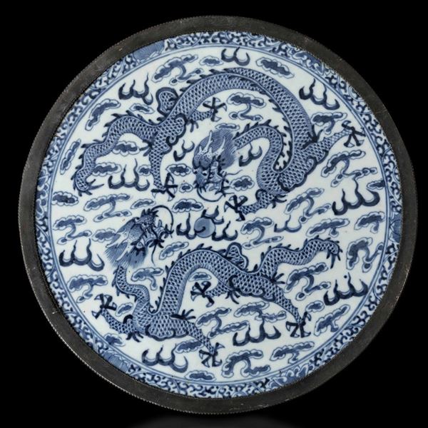 Placca circolare in porcellana bianca e blu con decoro di draghi tra le nuvole, Cina, Dinastia Qing, XIX secolo