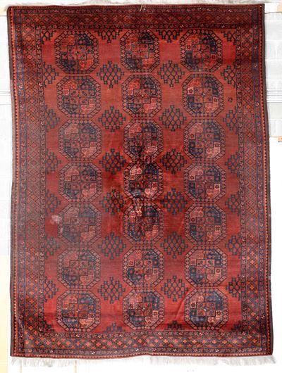 Tappeto afgano, inizio XX secolo, campo rosso scuro con gul ripetute