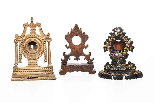 Tre casse di orologi in legno intagliato. XIX secolo