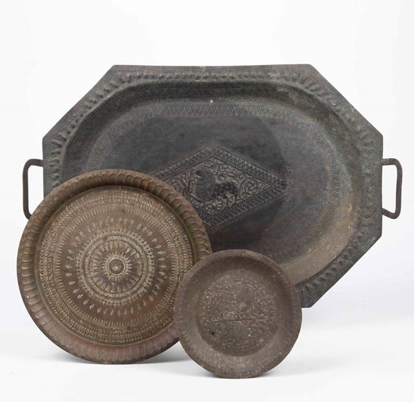 Un vassoio e due piatti in ottone sbalzato e cesellato. Arte del vicino oriente (Persia?) XIX secolo