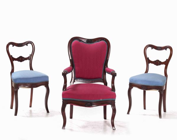 Poltrona e coppia di sedie in mogano intagliato, XIX secolo